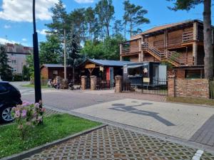 a building on the side of a street at Domki Pod Dębami in Pobierowo +6 photos