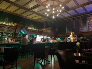 a bar with tables and chairs in a restaurant at The Inn at 2nd & C in Eureka