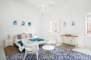 a bedroom with a bed and a table and chairs at Chic, Stylish Traditional Townhouse with Terrace - St. Paul’s Bay in St Paul's Bay