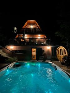 a swimming pool in front of a house at night at Chalet Calla in Mrkopalj