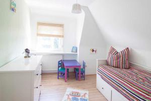 a small room with a bed and a table at Ferienwohnung Waldblick in Bad König