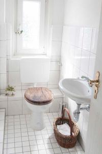 a white bathroom with a toilet and a sink at Ferienwohnung Waldblick in Bad König