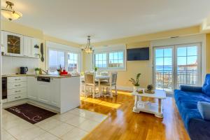 a kitchen and living room with a blue couch at OMIŠ Dream house in Omiš