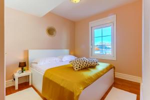 a bedroom with a bed and a window at OMIŠ Dream house in Omiš