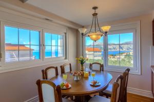 a dining room with a table and chairs and windows at OMIŠ Dream house in Omiš +146 photos