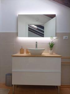 a bathroom with a sink and a mirror at Loving My Rooms 1 - Deliziosa Mansarda in Centro in Gorizia