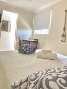 a bedroom with a large bed with a pillow on it at Pousada OCEAN in Saquarema