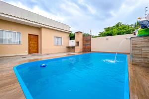 a swimming pool in the backyard of a house at Casa c piscina em frente ao mar-Barra de Sao Joao in Casimiro de Abreu