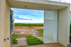 a garage door with a view of the ocean at Casa c piscina em frente ao mar-Barra de Sao Joao in Casimiro de Abreu
