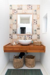 a bathroom with a sink and a mirror at Chic, Stylish Traditional Townhouse with Terrace - St. Paul’s Bay in St Paul's Bay