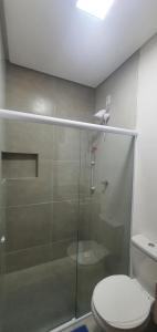 a bathroom with a glass shower with a toilet at Kbanas Milagres in São Miguel dos Milagres