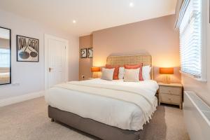 a bedroom with a large bed and two lamps at Be London - The Soho Residences in London