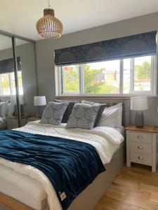 a bedroom with a large bed and two windows at Muller residence in Bristol