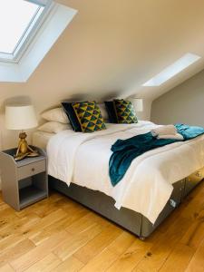 a bedroom with a large bed and a lamp on a wooden floor at Muller residence in Bristol
