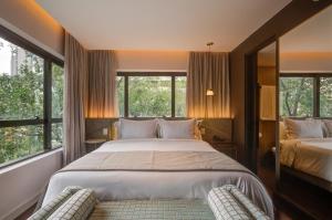 Cama ou camas em um quarto em Qoya São Paulo Paulista, Curio Collection by Hilton