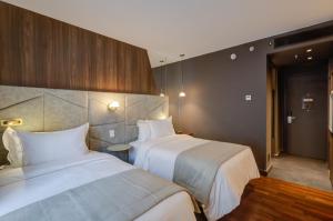 Cama ou camas em um quarto em Qoya São Paulo Paulista, Curio Collection by Hilton