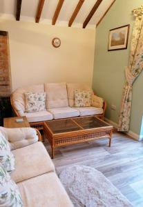 a living room with a couch and a coffee table at Poplar Cottage in Woodhall Spa