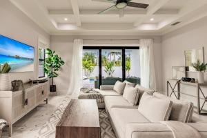 a living room with a couch and a table at Brand New Luxury Naples 4br W Pool By Vanderbilt Beach Coastal Sol By Boutiq in Naples