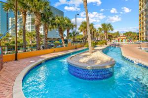 a swimming pool with a palm tree in the middle at Caravelle Resort #622 in Myrtle Beach
