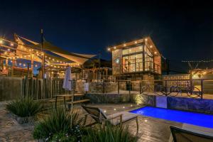 a resort with a swimming pool at night at Sirius Valle in Valle de Guadalupe
