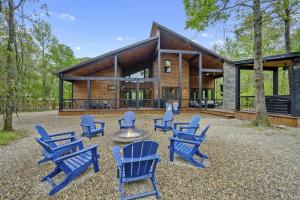 a group of blue chairs in front of a house at Fun & Inviting Modern Luxury 4br Retreat At Broken Bow Lake Features Hot Tub, Fire Pit, Playground And More Once In A Blue Moon By Boutiq in Broken Bow