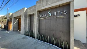 a building with a sign that reads baja suites at Baja Suites - Departamentos Vacacionales in Ensenada