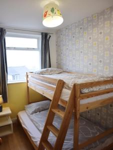 a bedroom with a bunk bed and a window at Lovely 3 beds house 6 guests King beds in Sheffield