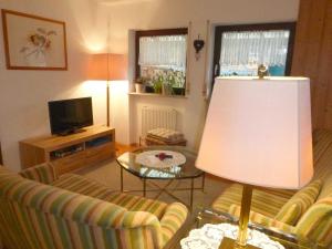 a living room with two couches and a table with a lamp at Ferienwohnung bei Rosi in Kirchzell