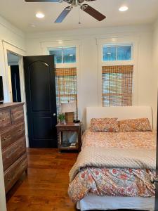 a bedroom with a bed and a dresser and windows at The Summer Palace in Inlet Beach