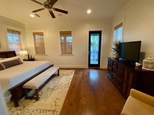 a bedroom with a bed and a flat screen tv at The Summer Palace in Inlet Beach +1 photo