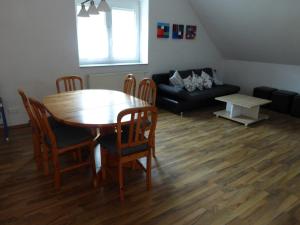 a living room with a table and chairs and a couch at Daumsmuhle in Mossautal