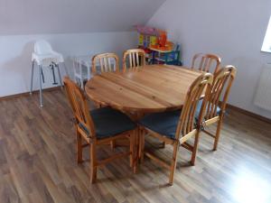 a wooden table and chairs in a room at Daumsmuhle in Mossautal