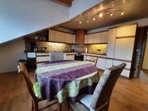 eine Küche mit einem Tisch und Stühlen im Zimmer in der Unterkunft Blumenschein-Ferienwohnung Obbe in Kirchzell
