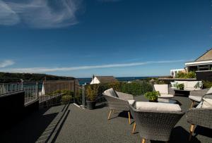 a balcony with chairs and a view of the ocean at The Haven, Fishguard, ideal for Beach, coastal path and town! in Fishguard