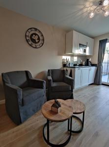 a living room with two chairs and a coffee table at Luxe Kamer aan Zee in Zoutelande