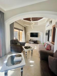 a living room with a couch and a table at Y 140 wast golf heated private pool in Hurghada