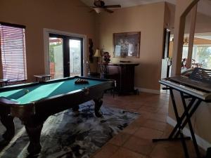 a living room with a pool table and a piano at Stunning Strip and Mountain Views in Las Vegas in Las Vegas