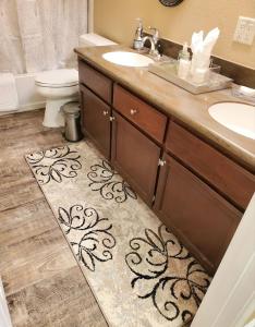 a bathroom with a sink and a toilet and a bathroom rug at Stunning Strip and Mountain Views in Las Vegas in Las Vegas