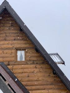 a roof of a wooden cabin with a window at Vikendica Aview in Štrpce