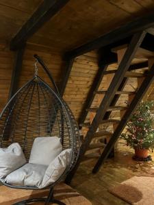 a swinging chair in a room with a christmas tree at Vikendica Aview in Štrpce