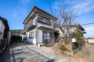 a white house with a tree in front of it at VILLENT KUJUKURI MARINE in Kujukuri