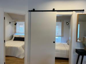 a sliding door leading to a bedroom with a bed at Casa das Manas in Nazaré