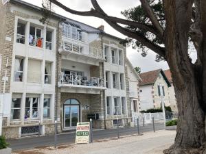 a building with a sale sign in front of it at Un cocon face à la plage in Saint-Trojan-les-Bains