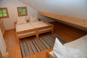 an attic room with two beds and a mattress at Ferienhaus Schöberlhütte in Vorderlainsach