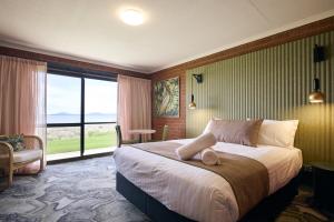 a hotel room with a bed and a large window at The Waterloo Hotel in Swansea