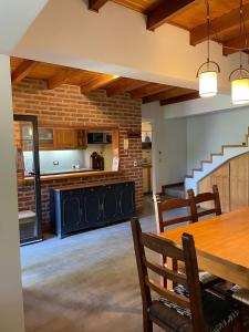 a kitchen and dining room with a table and a staircase at Departamentocasa zona centro in San Martín de los Andes