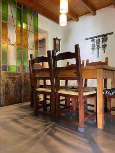 a dining room with a table and chairs and stained glass at Departamentocasa zona centro in San Martín de los Andes