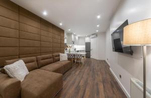 a living room with a couch and a table at VICTORY-30 LUXURY APARTMENT CEnTER in Kyiv