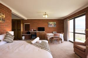 a hotel room with a bed and a dining room at The Waterloo Hotel in Swansea