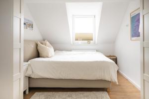 um pequeno quarto com uma cama e uma janela em Ko-Living - urbanes Apartment am Zoo em Giebichenstein